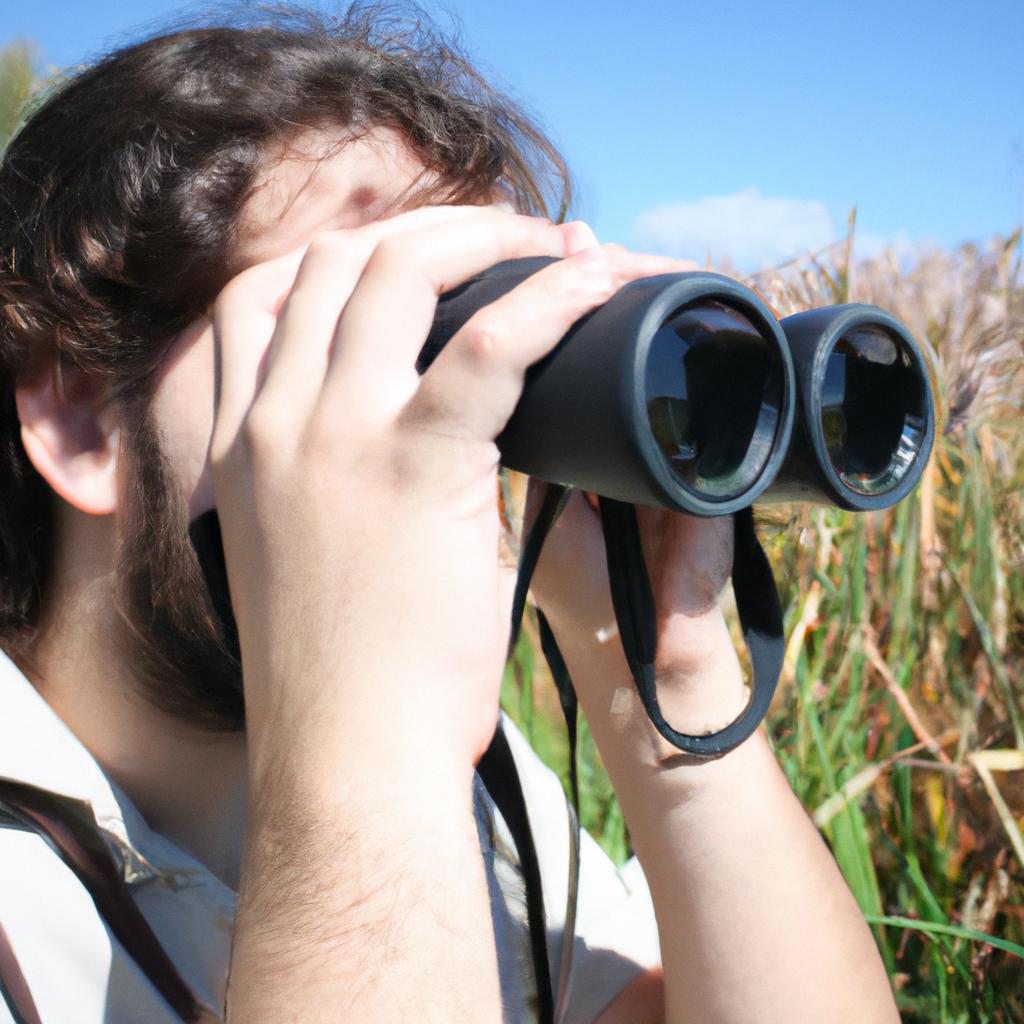 Person holding binoculars, photographing birds