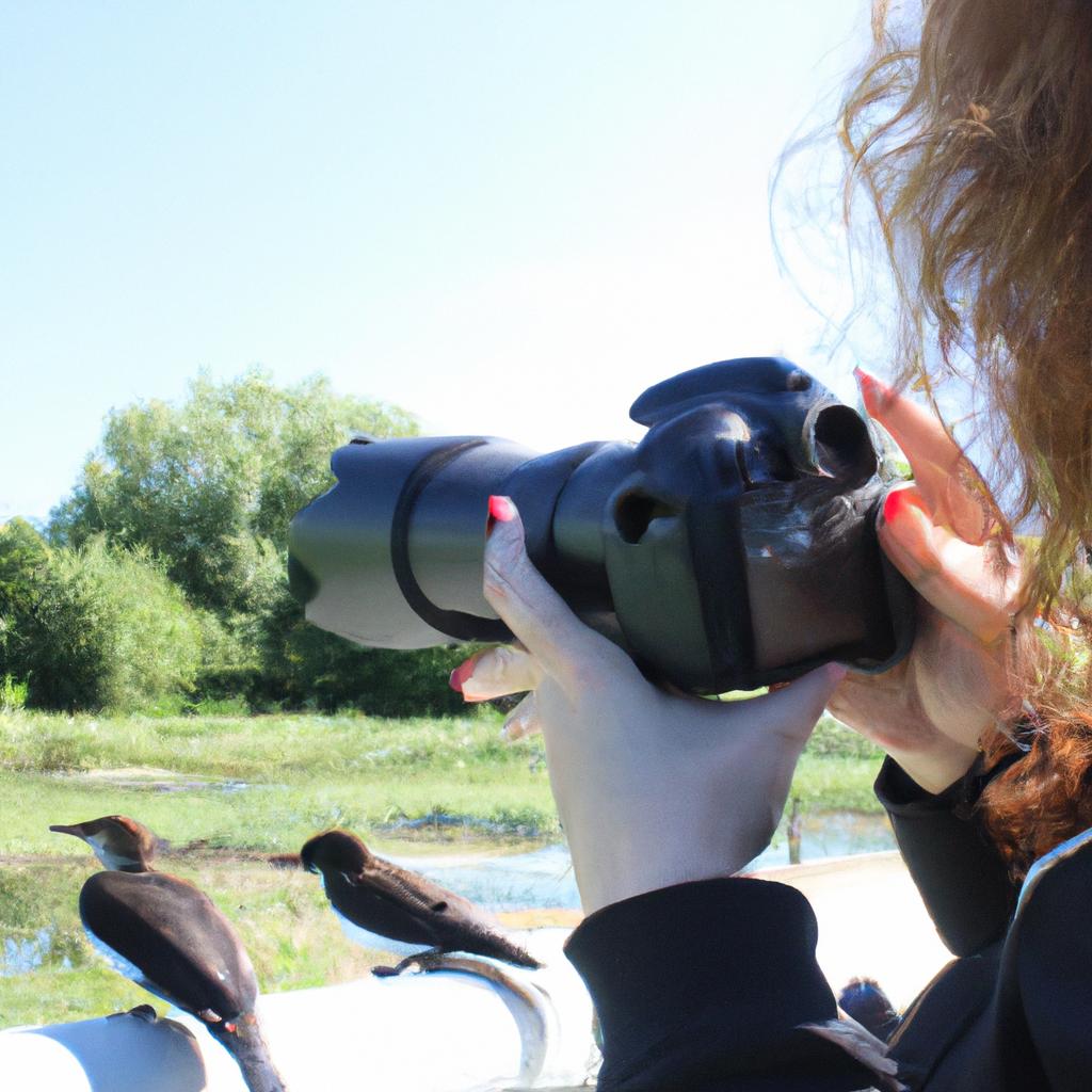 Person holding a camera, photographing birds