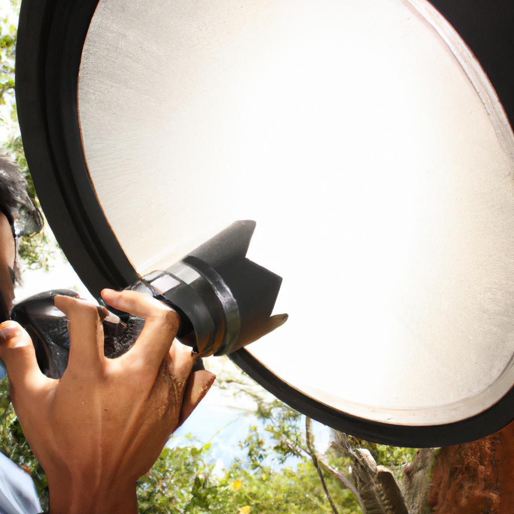 Person using camera with reflector