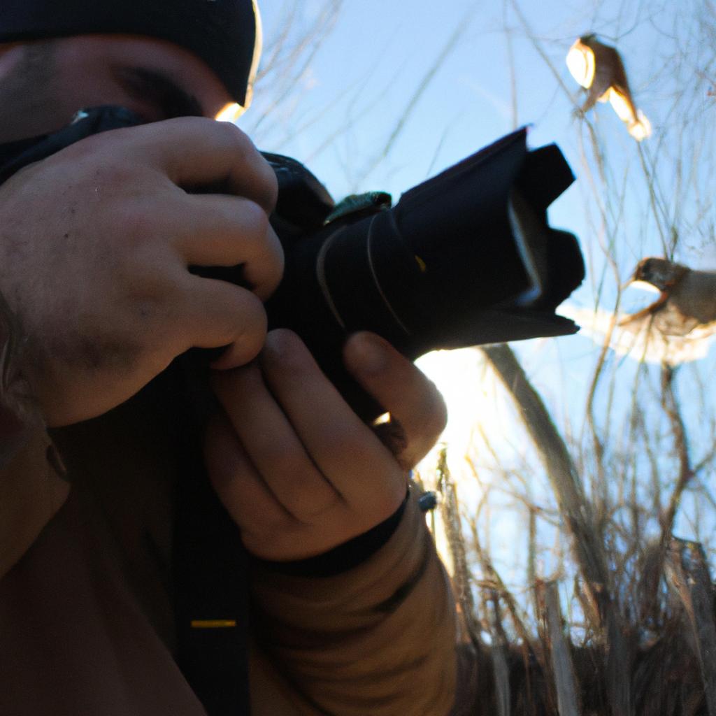 Person holding camera, photographing birds
